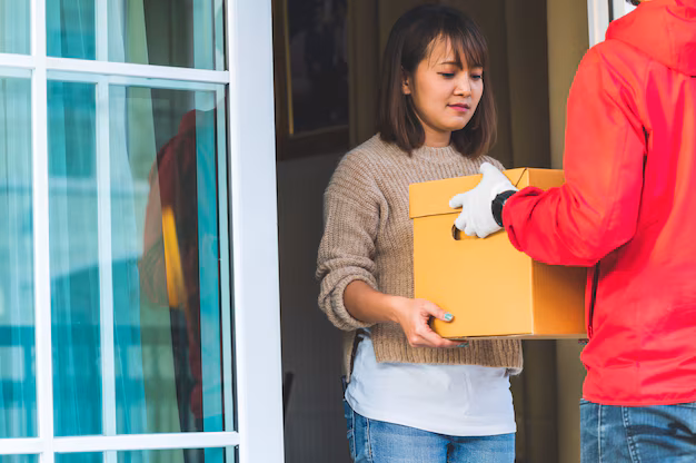 delivery man giving boxes young women home courier service concept_43157 1950